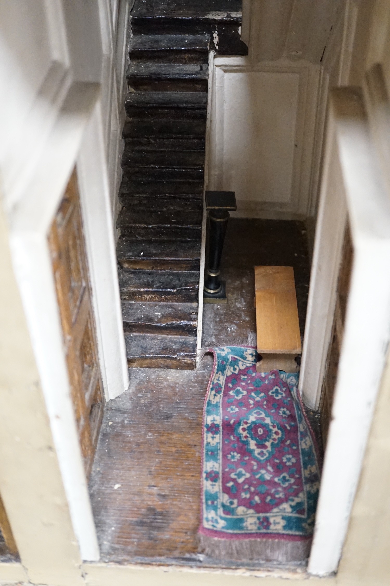 An early 19th century painted doll's house with block work facade enclosing a four room interior with central staircase, to be sold with assorted later furniture and accessories, width 117cm, depth 48cm, height with asso
